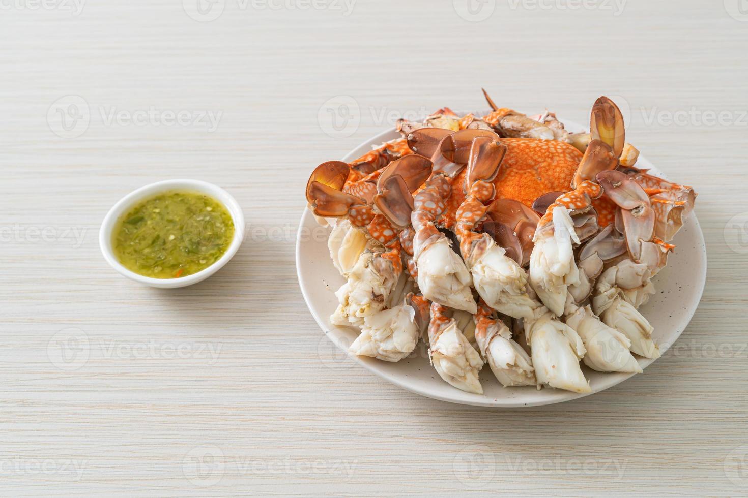 Steamed blue crab with spicy seafood sauce photo
