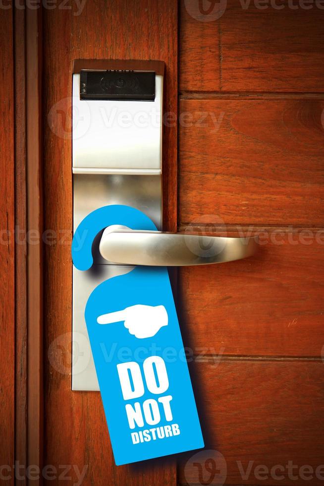 Do not disturb sign hang on door knob photo