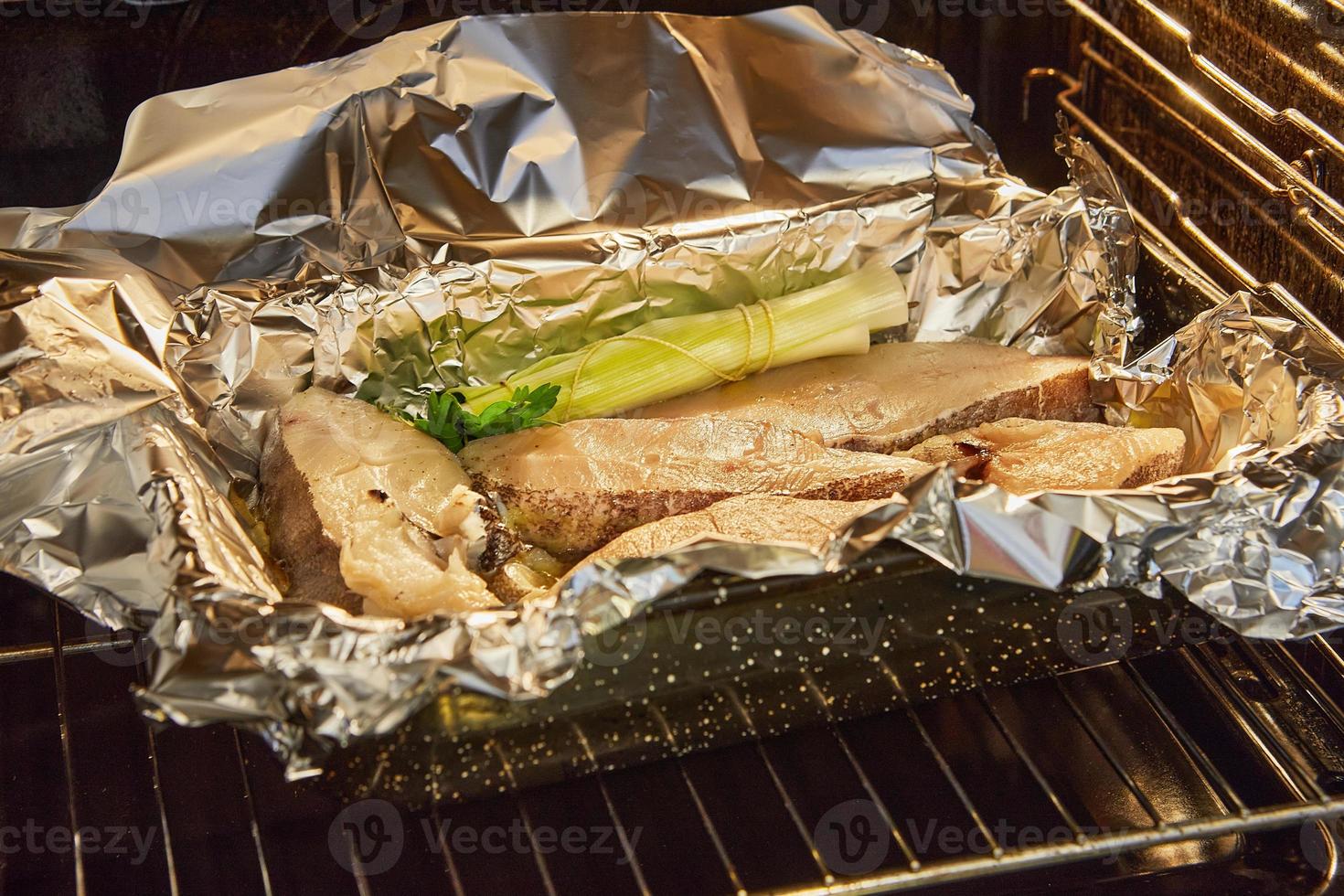 Fish bass in the oven before baking with bouquet for flavor photo