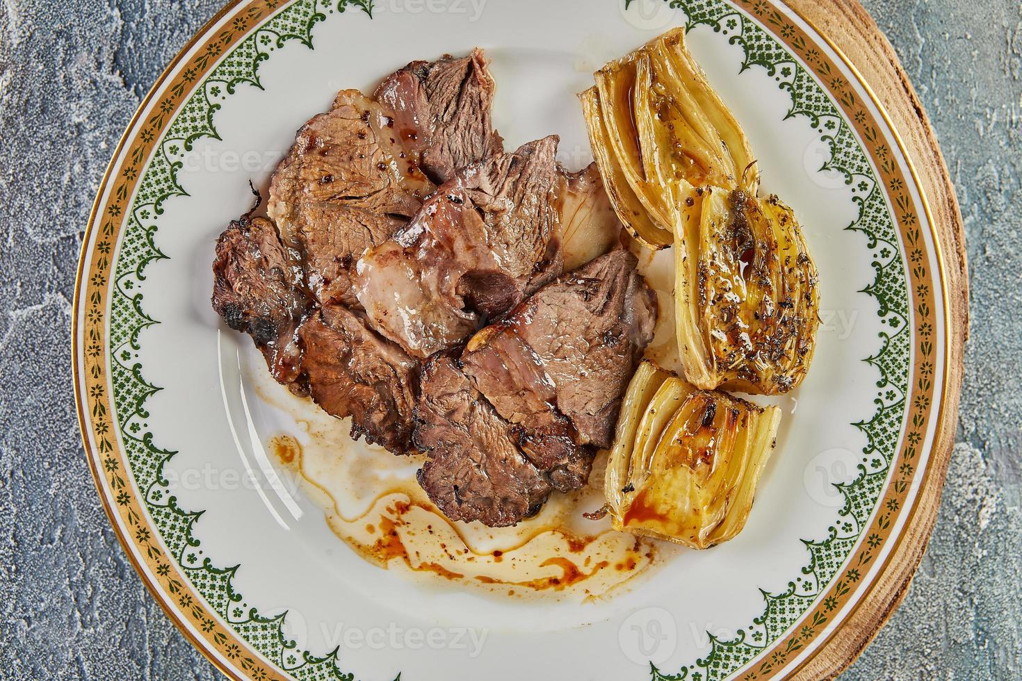 Chicory stewed on board. Exquisite French food photo