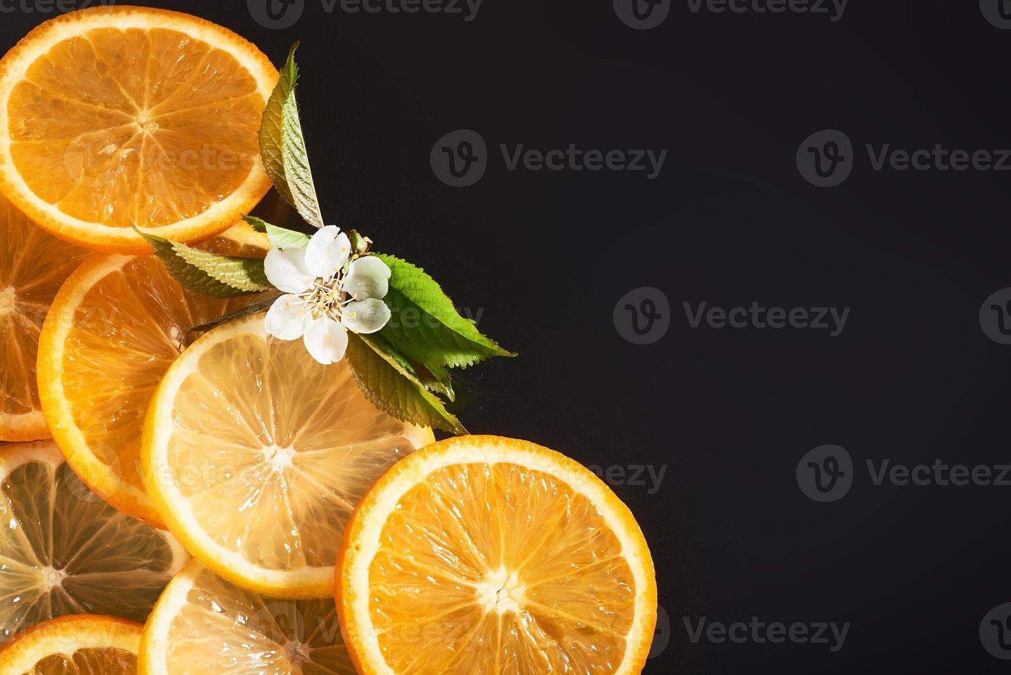 slices of orange and lemon, isolated on a black background photo