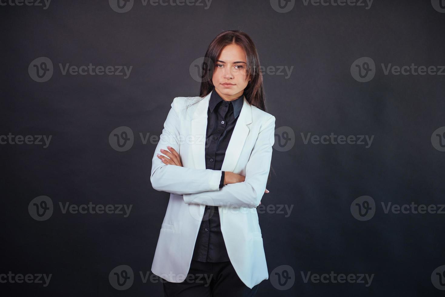 Portrait of beautiful smart young businesswoman in business attire photo