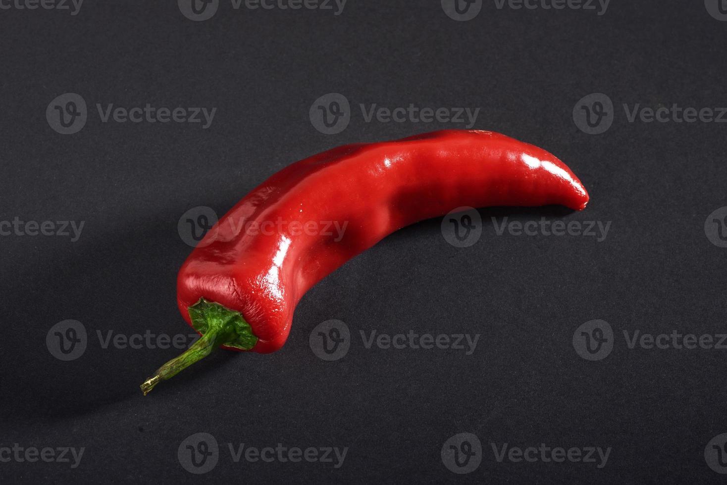 Red chili peppers isolated on a black background photo