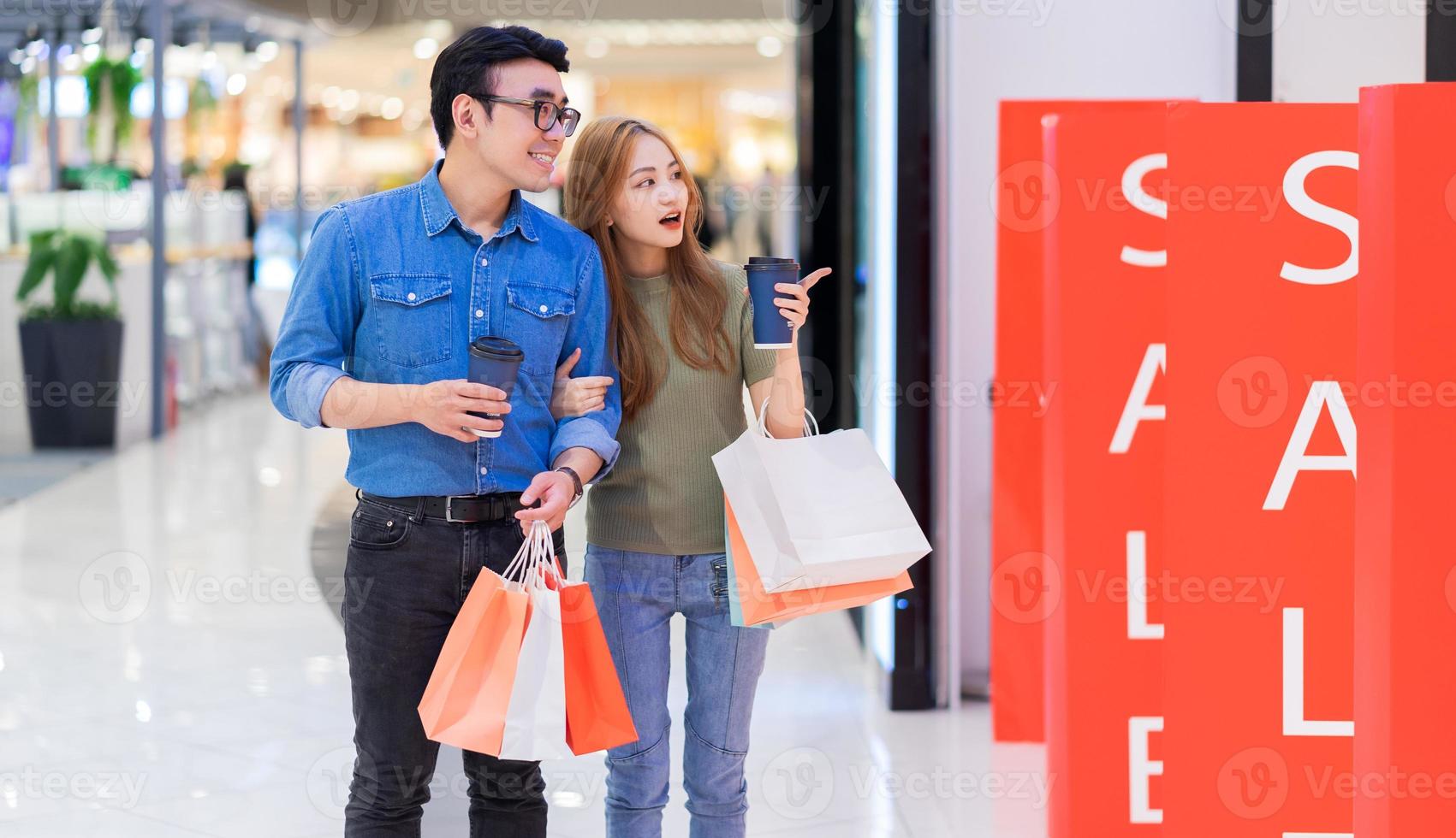 pareja asiática de compras en el centro comercial foto