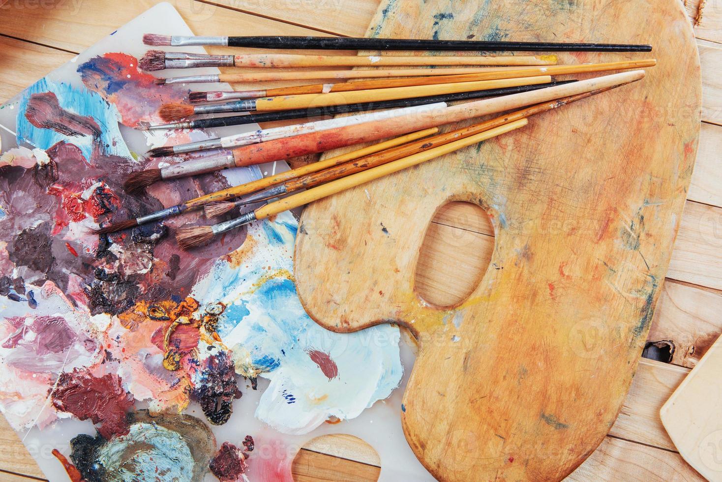 colorful paint palette with brushes photo