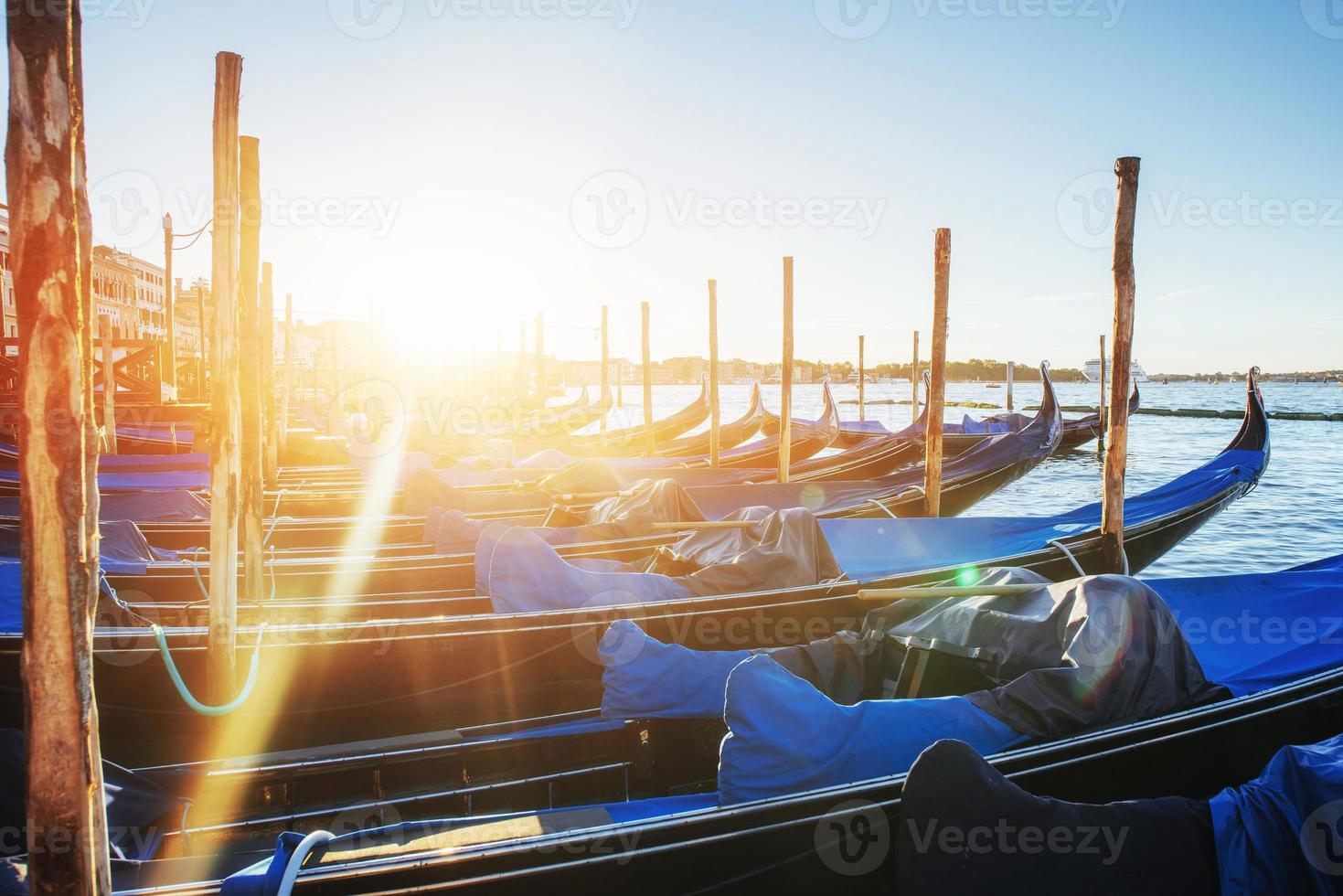 Gondolas in Venice - sunset with San Giorgio Maggiore church. Venice, Italy photo