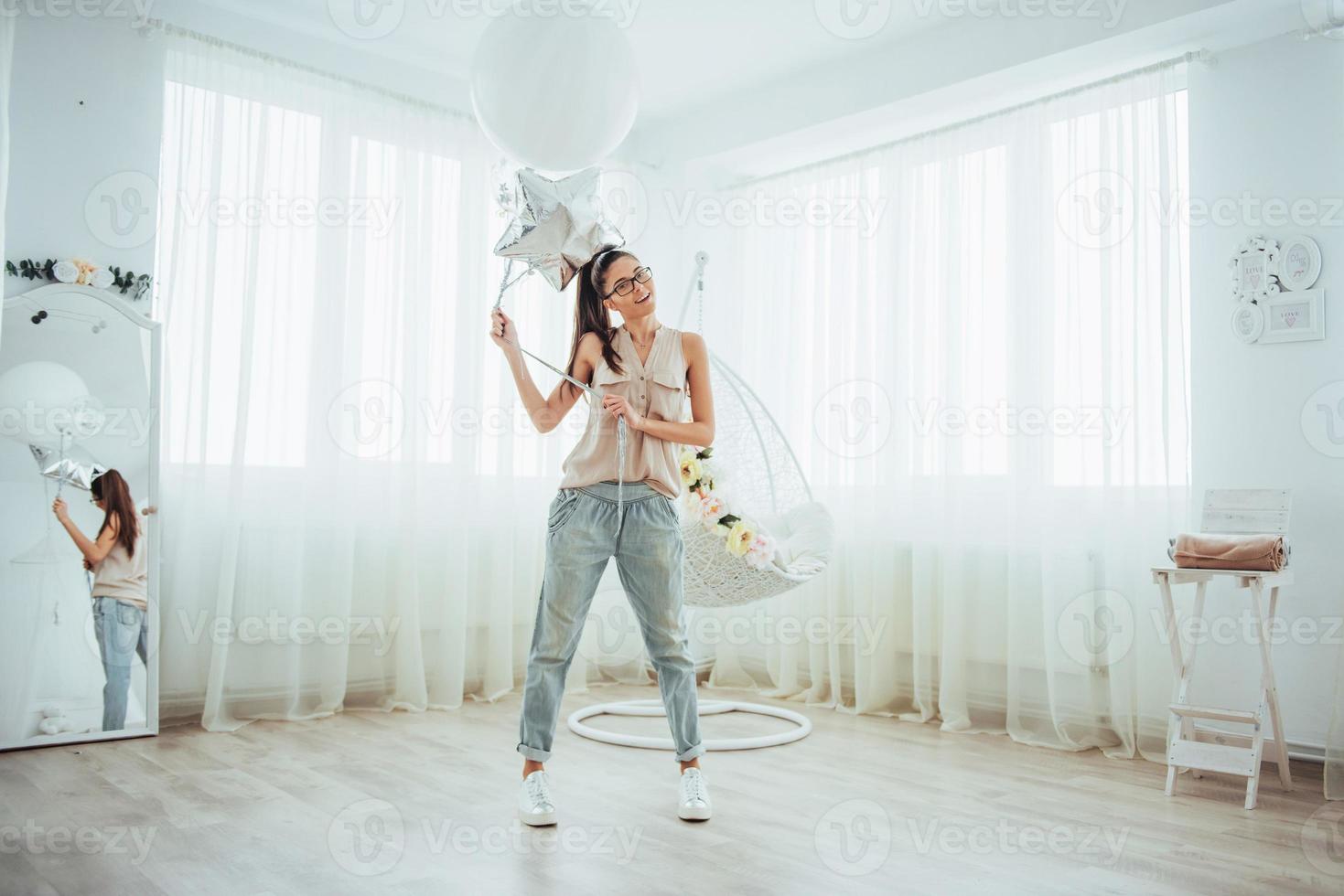 Fashion photo beautiful woman with balloons. Girl posing. photo studio