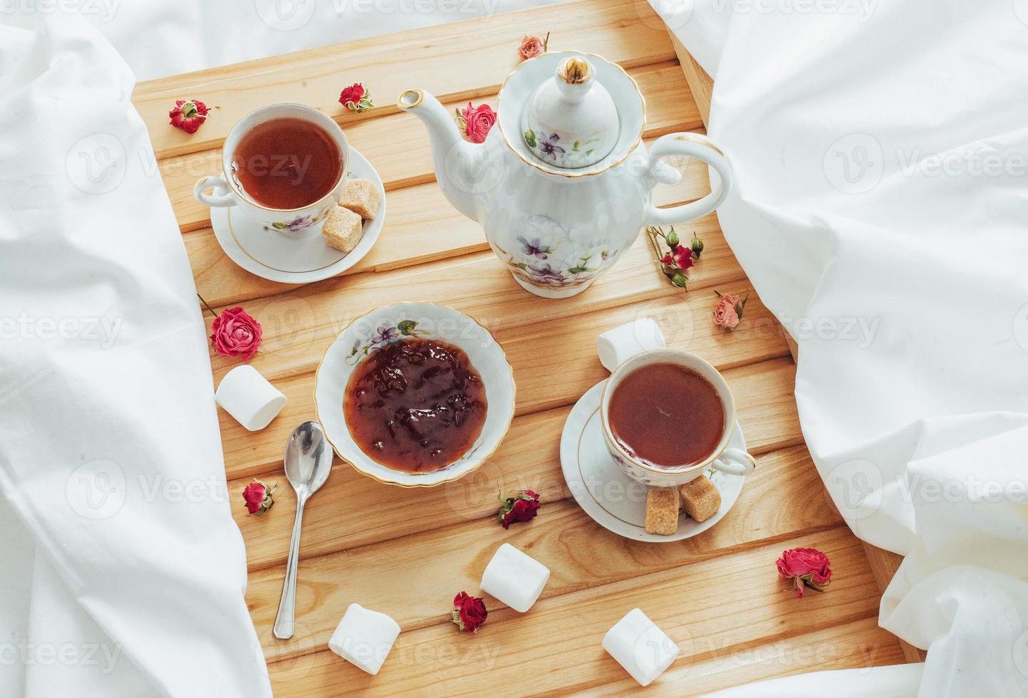 cup of tea, teapot, spoon and sugar isolated photo