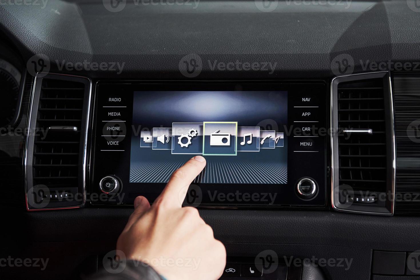 Smart car and internet of things IOT concept. Finger point to car 's console and icons popup out of screen photo