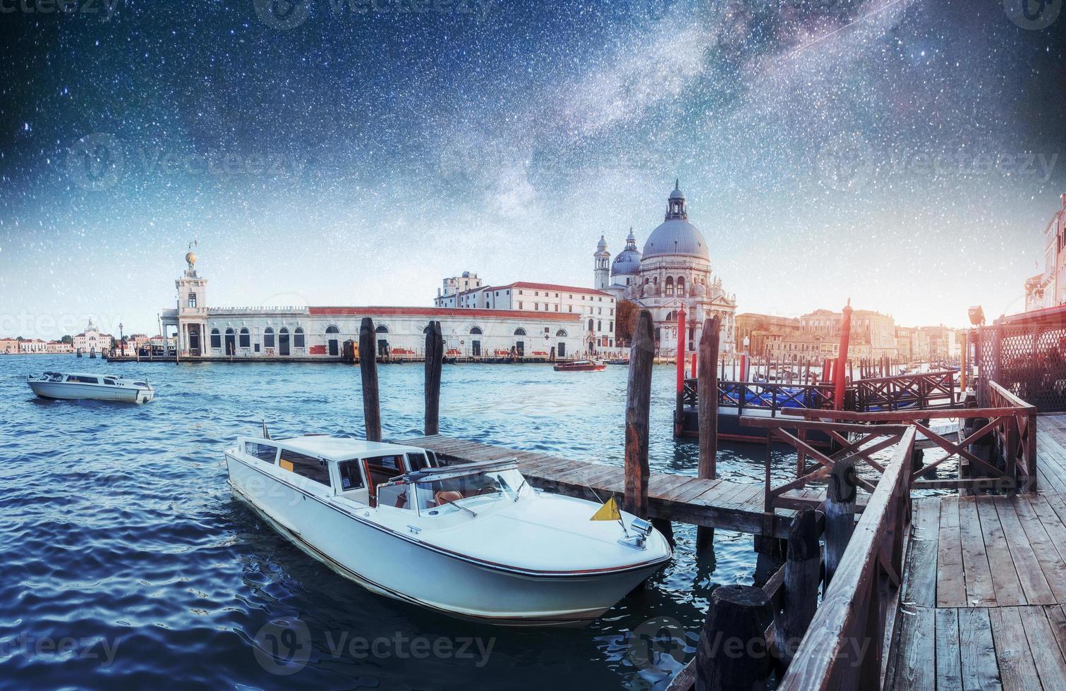 Gondolas on the canal at night in Venice, San Giorgio Maggiore church. San - Marco. Fantastic starry sky and the Milky Way photo