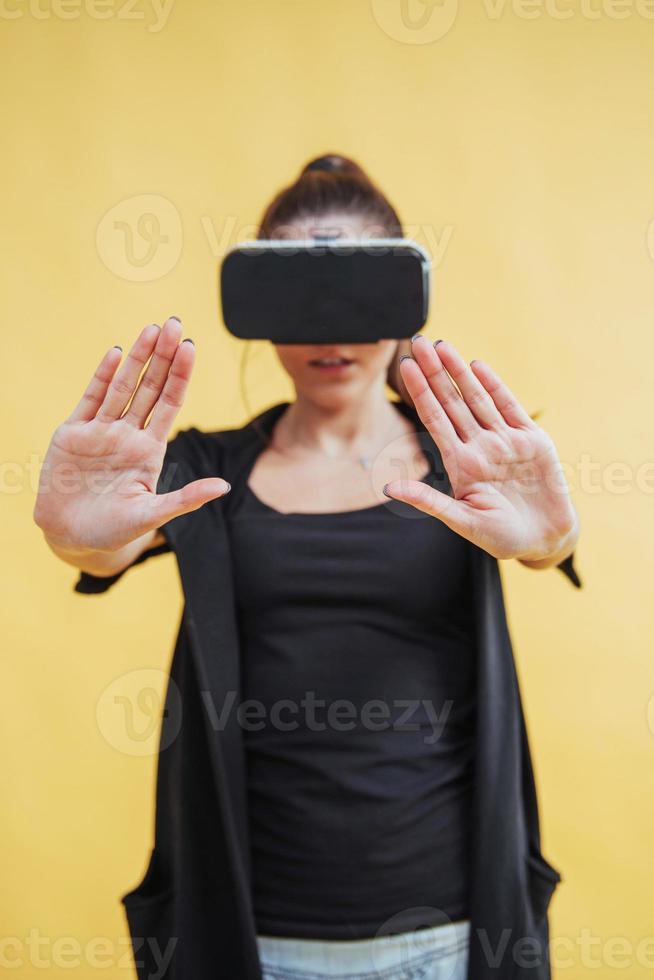 Happy woman gets experience of using VR-glasses virtual reality headset photo