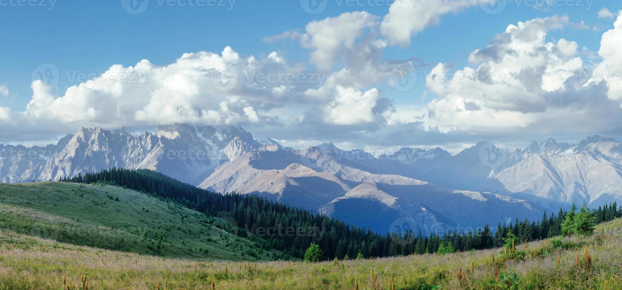 Fantastic snow-capped mountains in the beautiful cumulus clouds. photo