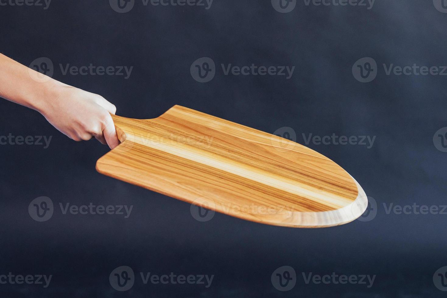 Wooden boards for pizza in hand woman photo