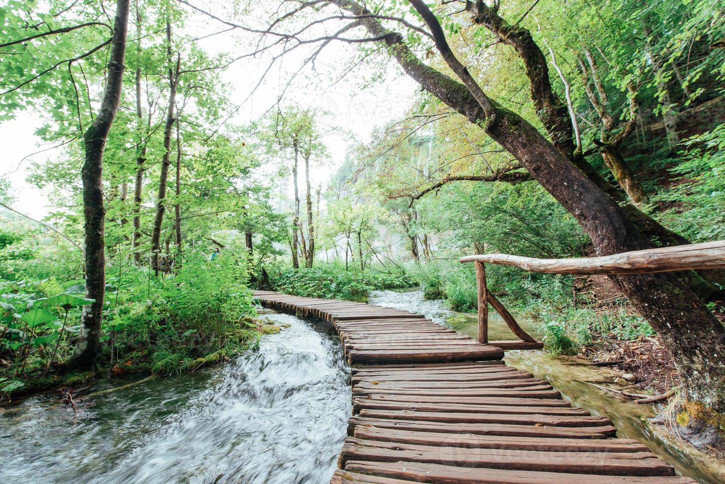 Plitvice Lakes National Park, tourist route on the wooden flooring along the waterfall photo