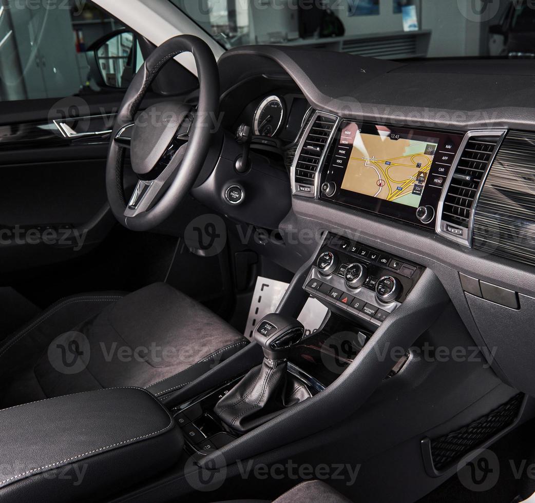 Luxury car Interior - steering wheel, shift lever and dashboard photo