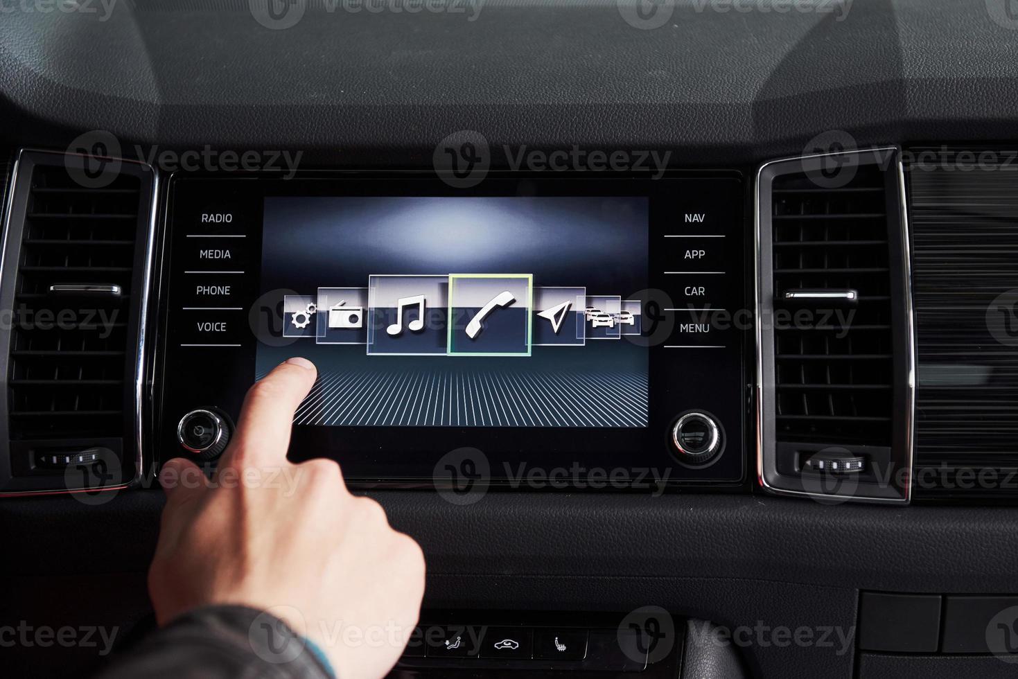 Smart car and internet of things IOT concept. Finger point to car 's console and icons popup out of screen photo