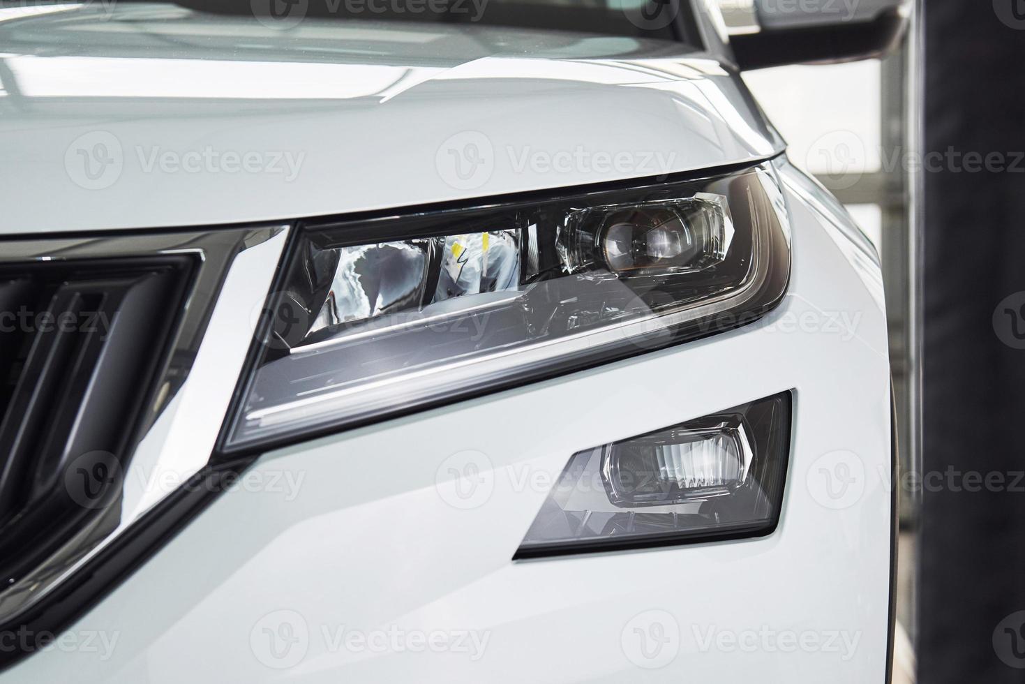 The headlights and the hood of a new luxury car photo