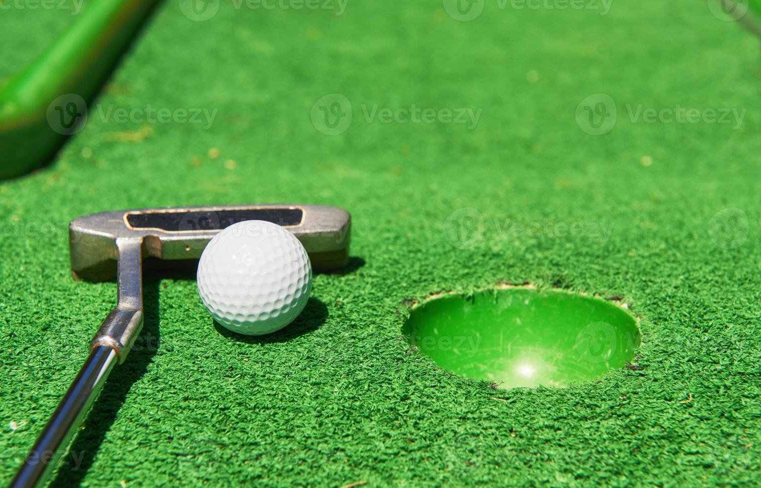 Golf ball and Golf Club on Artificial Grass photo