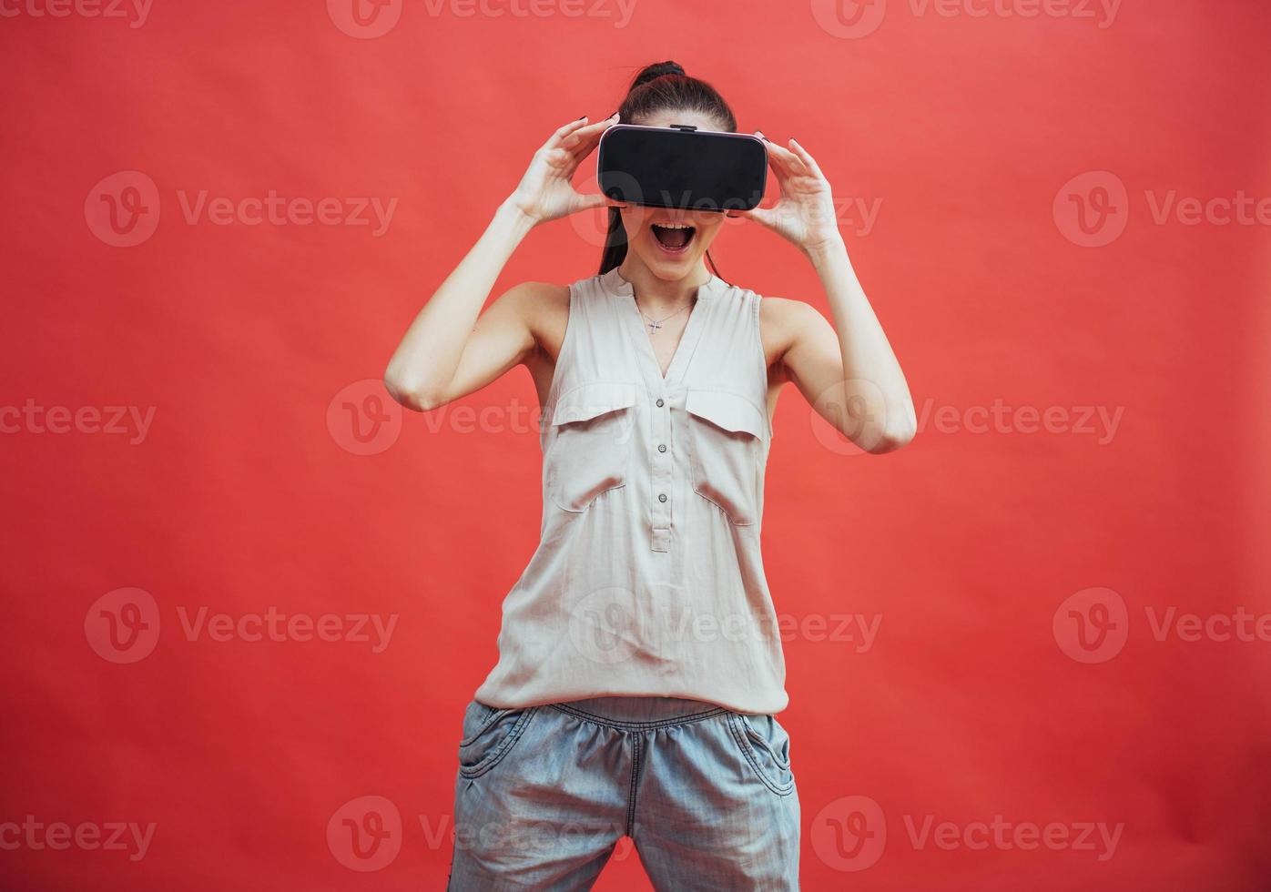 portrait of happy smiling young beautiful girl, gain experience using VR-headset virtual reality glasses, isolated photo