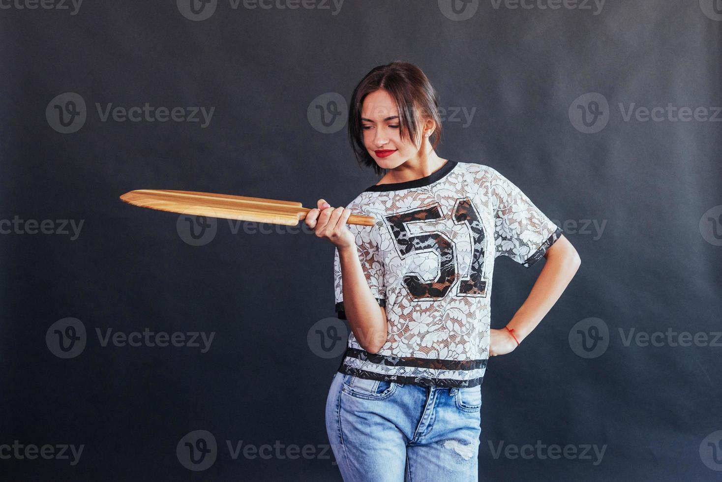 Beautiful young woman with a wooden board photo