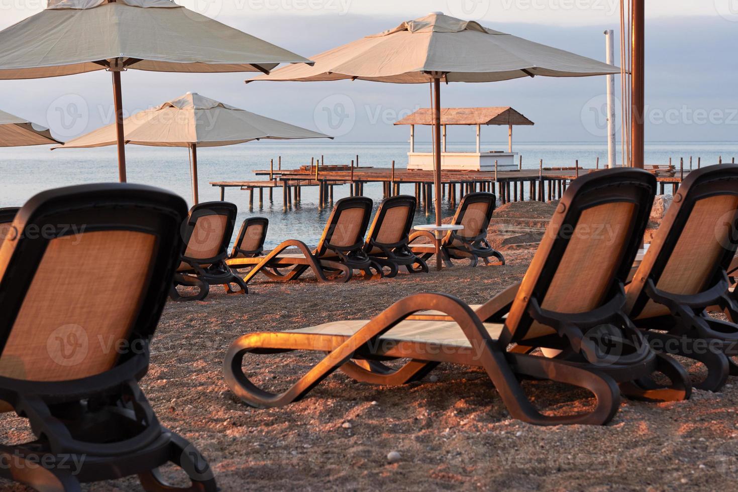 Scenic view of private sandy beach on the beach with sun beds against the sea and mountains. Amara Dolce Vita Luxury Hotel. Resort. Tekirova-Kemer photo