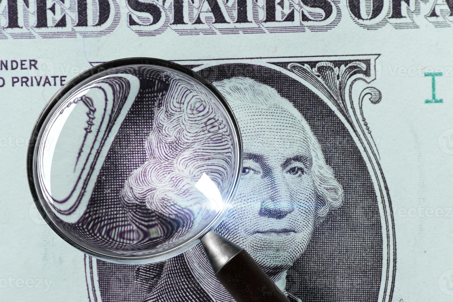 1 US Dollar under magnifying glass photo