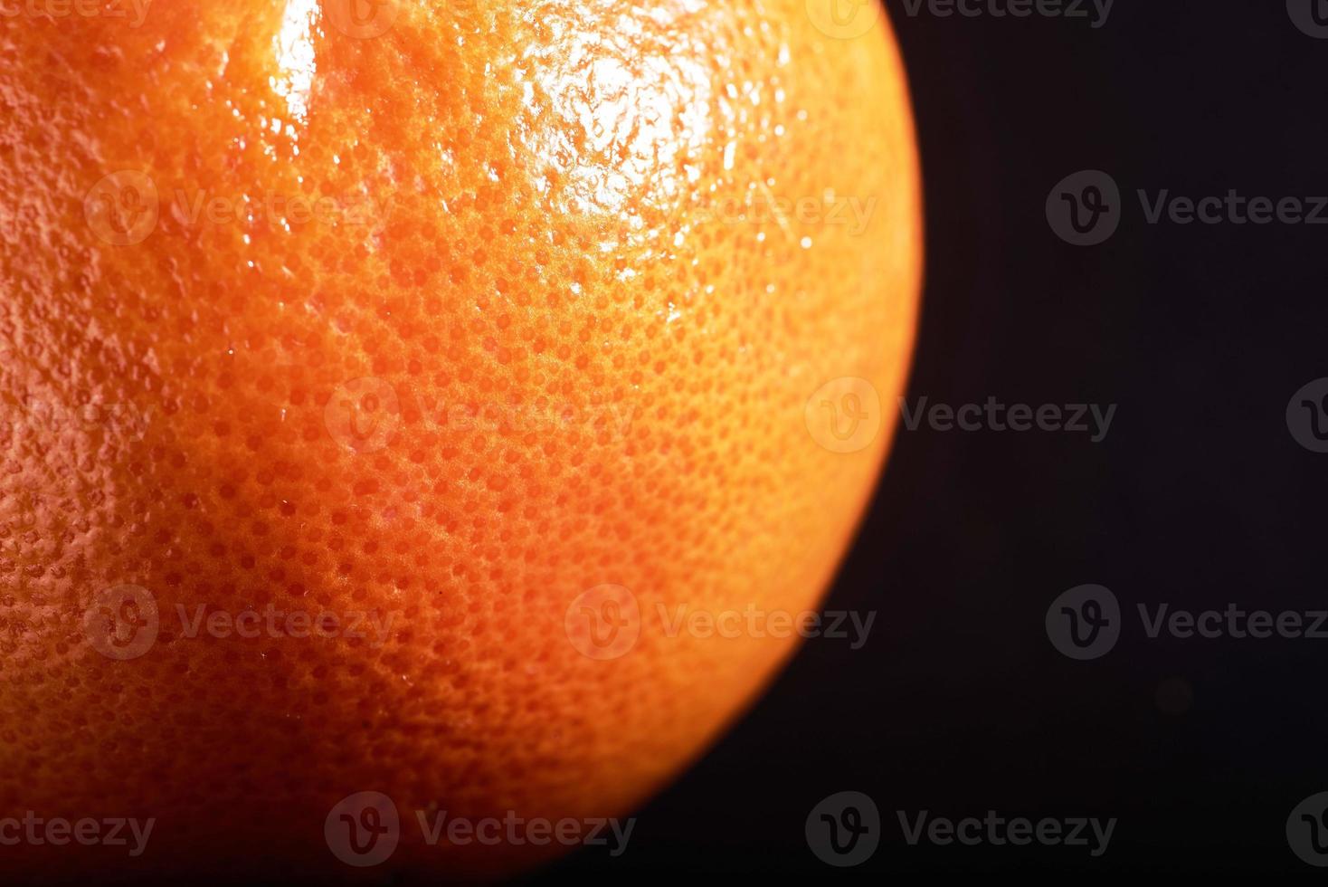 macro fresh orange peel on a black background. photo