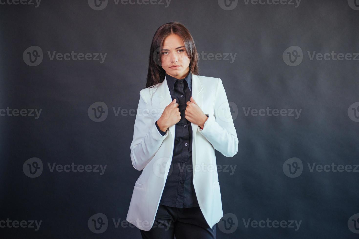 Portrait of beautiful smart young businesswoman in business attire photo