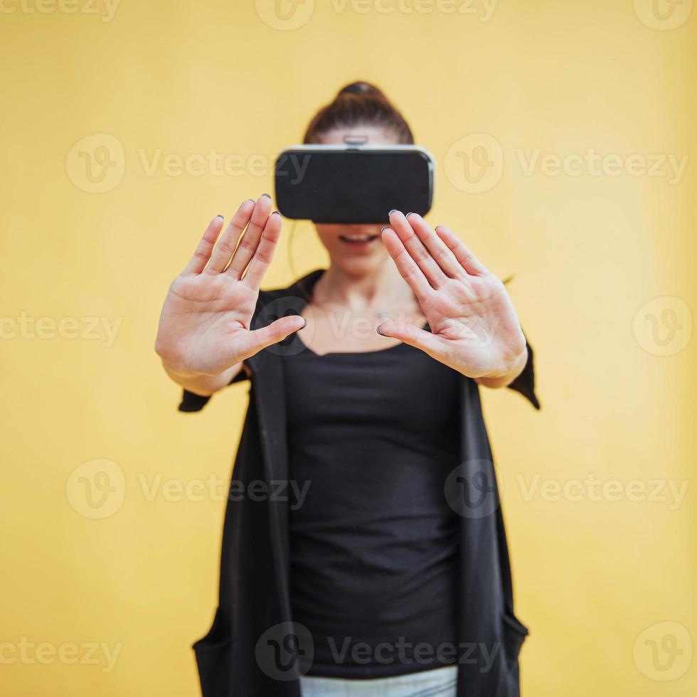 Happy woman gets experience of using VR-glasses virtual reality headset photo