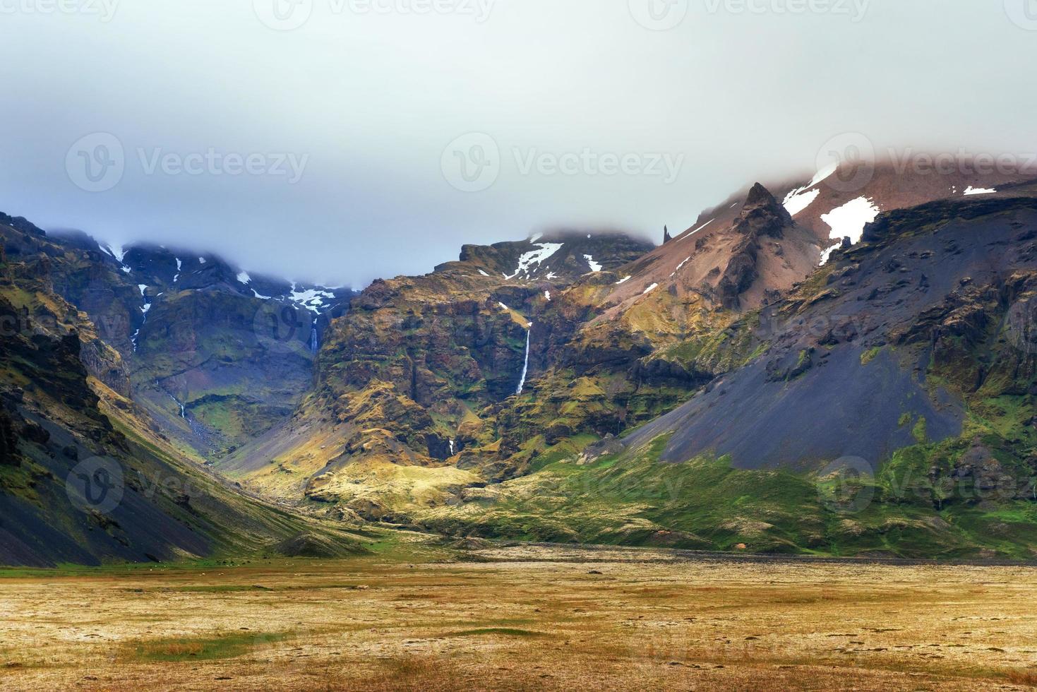 Gentle slopes of snow-capped mountains and glaciers. Wonderful Iceland in the spring. photo