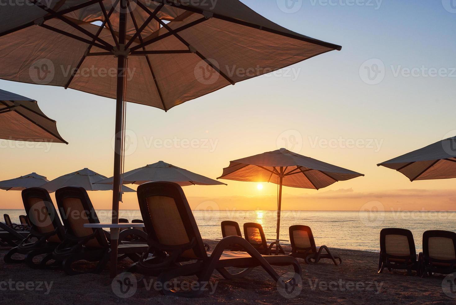 Scenic view of sandy beach on the beach with sun beds and umbrellas open against the sea and mountains. Amara Dolce Vita Luxury Hotel. Resort. Tekirova-Kemer photo