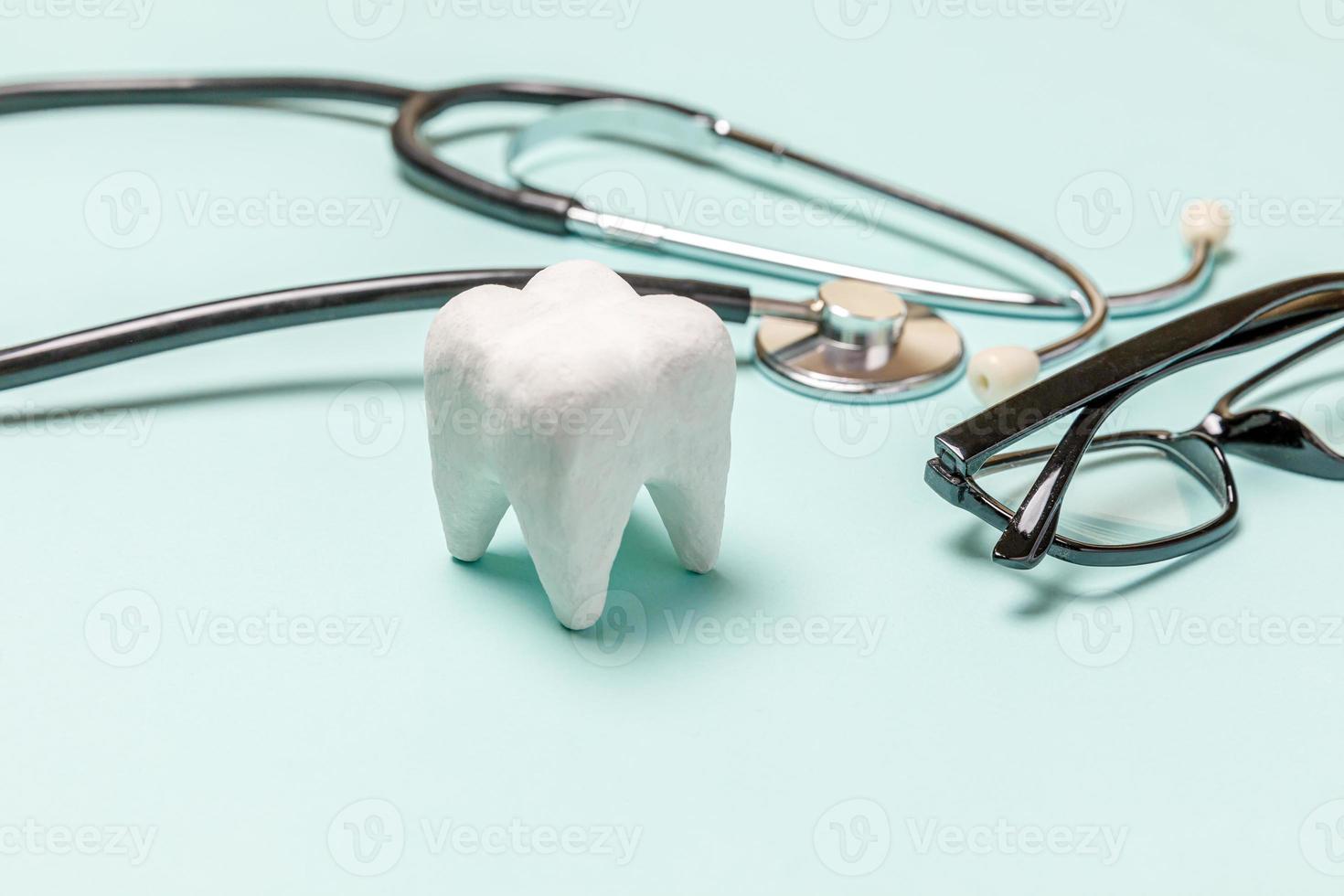 concepto de atención dental de salud. equipo de medicina estetoscopio gafas blancas de dientes sanos aisladas sobre fondo azul pastel. dispositivo de instrumento para médico dentista. higiene bucal dental, día del dentista. foto