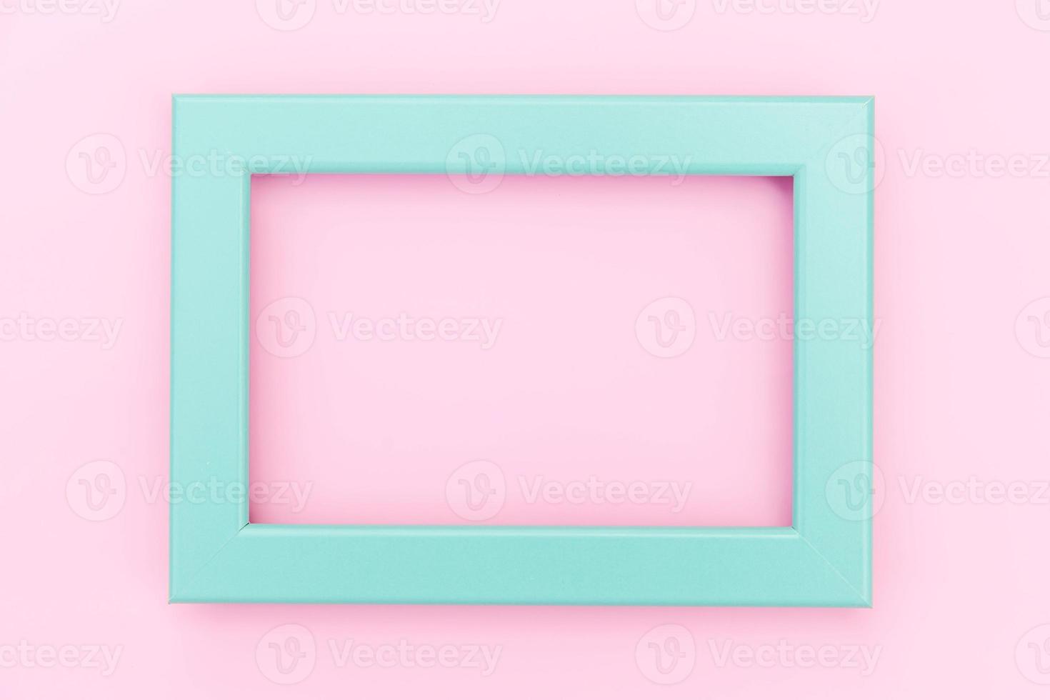 Simply design with empty blue frame isolated on pink pastel colorful background. Top view, flat lay, copy space, mock up. Minimal concept. photo