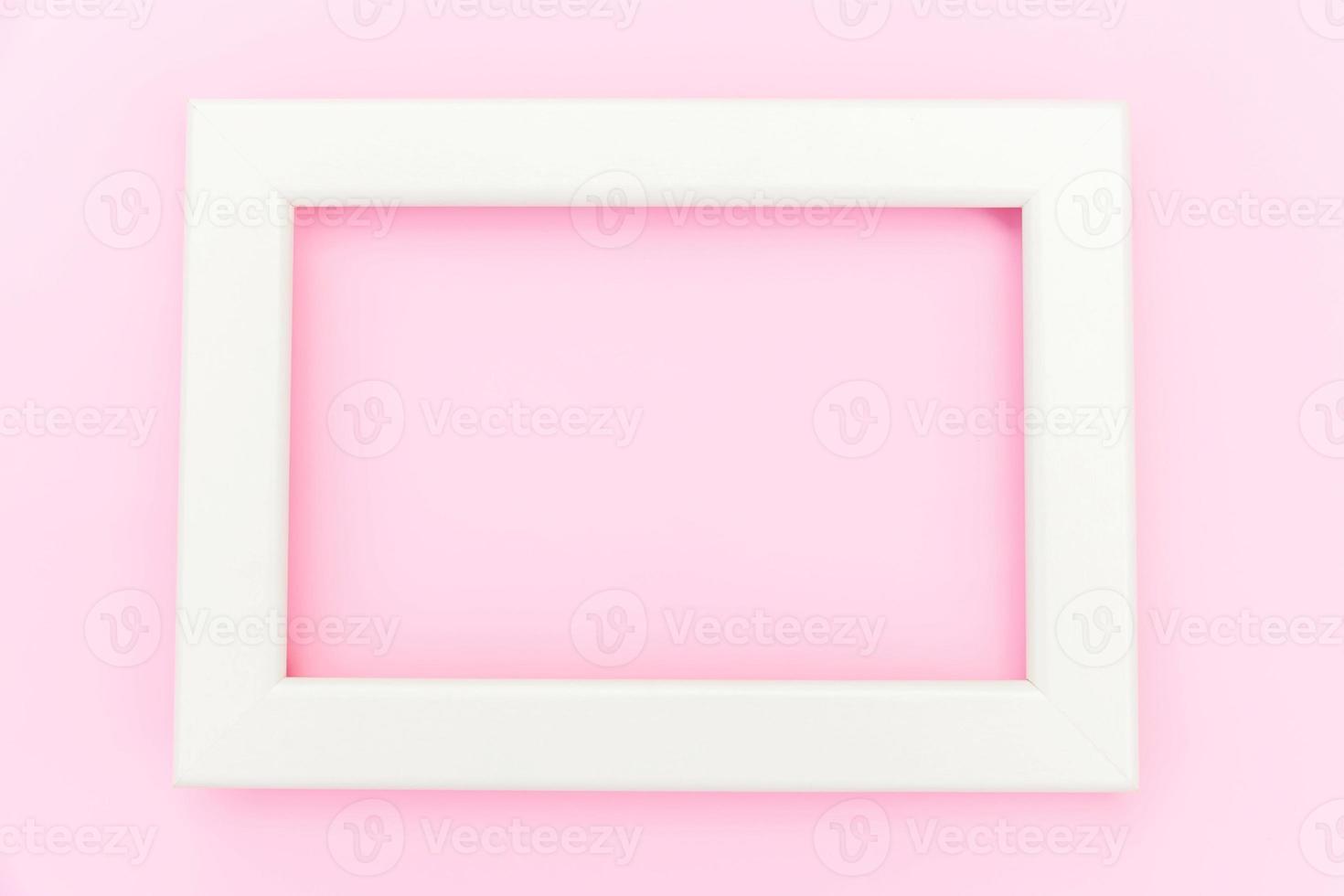 Simply design with empty pink frame isolated on pink pastel colorful background. Top view, flat lay, copy space, mock up. Minimal concept. photo