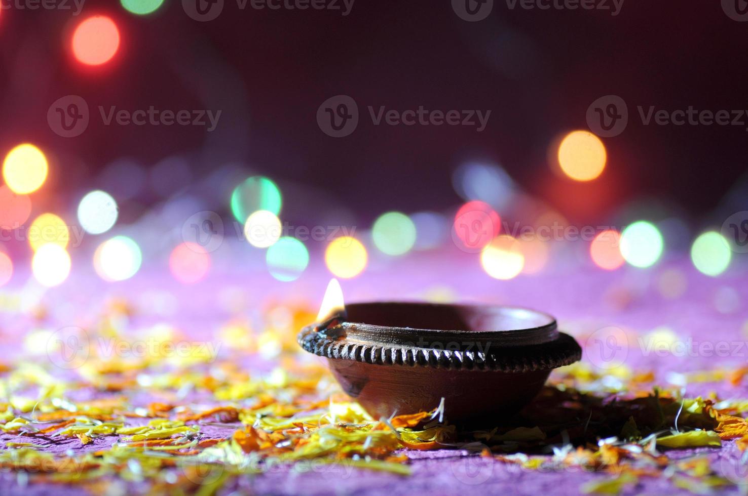 Clay diya lamps lit during Diwali Celebration. Greetings Card Design Indian Hindu Light Festival called Diwali photo