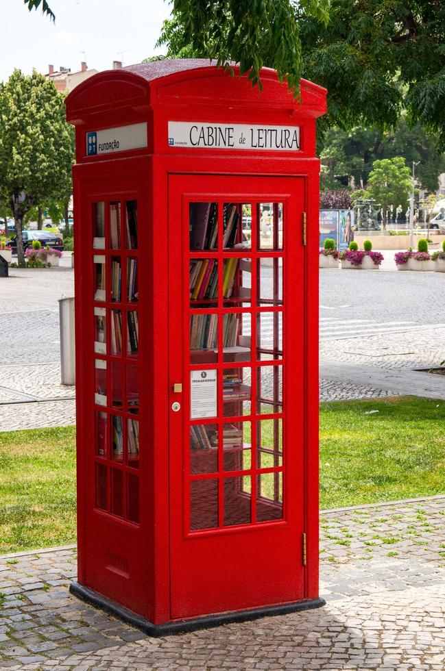 Leiria, Portugal - June 22, 2017 Red telephone box with library books inside photo