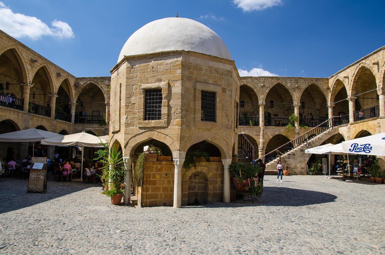 Nicosia, Cyprus - September 24, 2017 Cafes, restaurants and souvenir shops in Caravanserai Buyuk Han the Great Inn in Nicosia, Lefkosa, North Cyprus photo