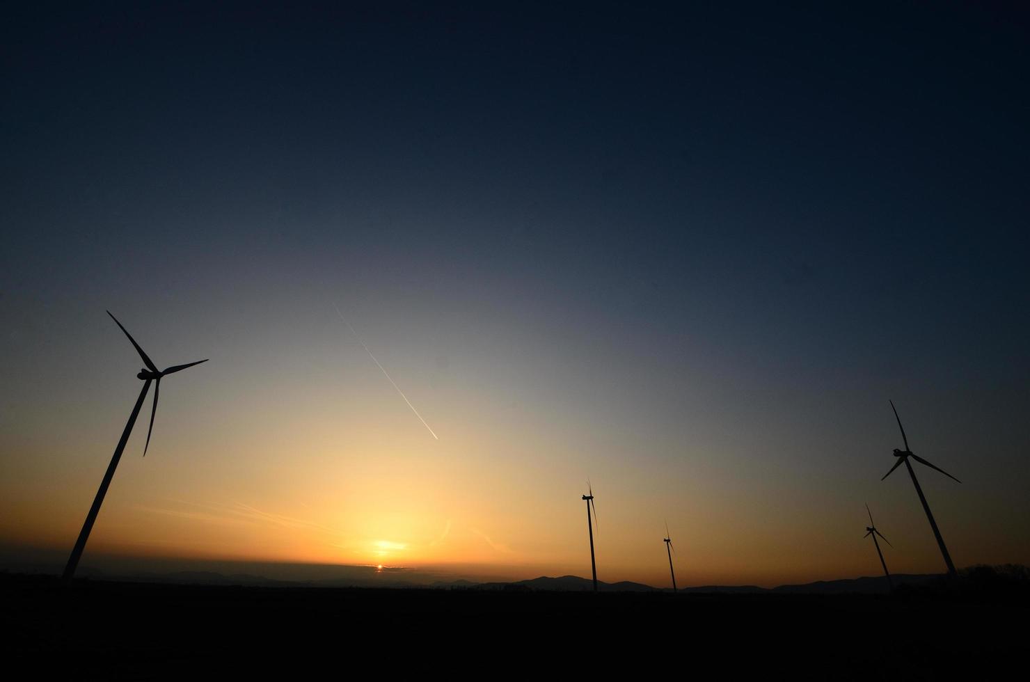 wind turbines in sunset photo