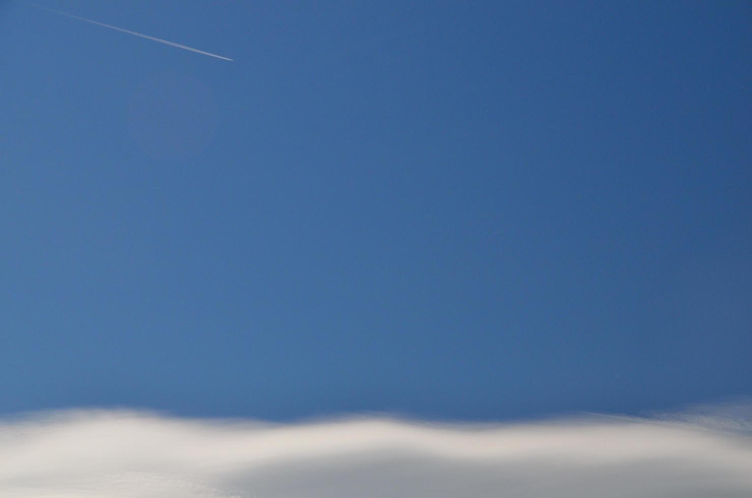 delicate white clouds and airplane photo