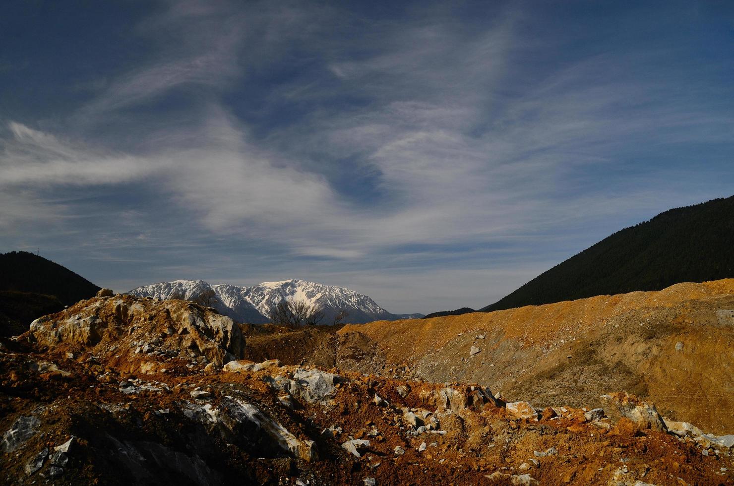 quarry with sky and snowy mountain photo