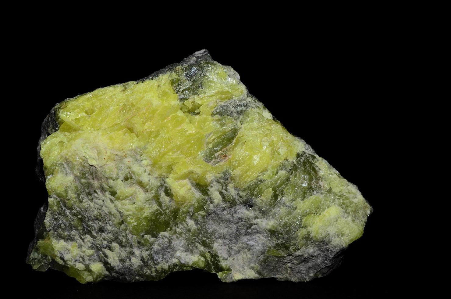 stone with yellow sulfur on black photo