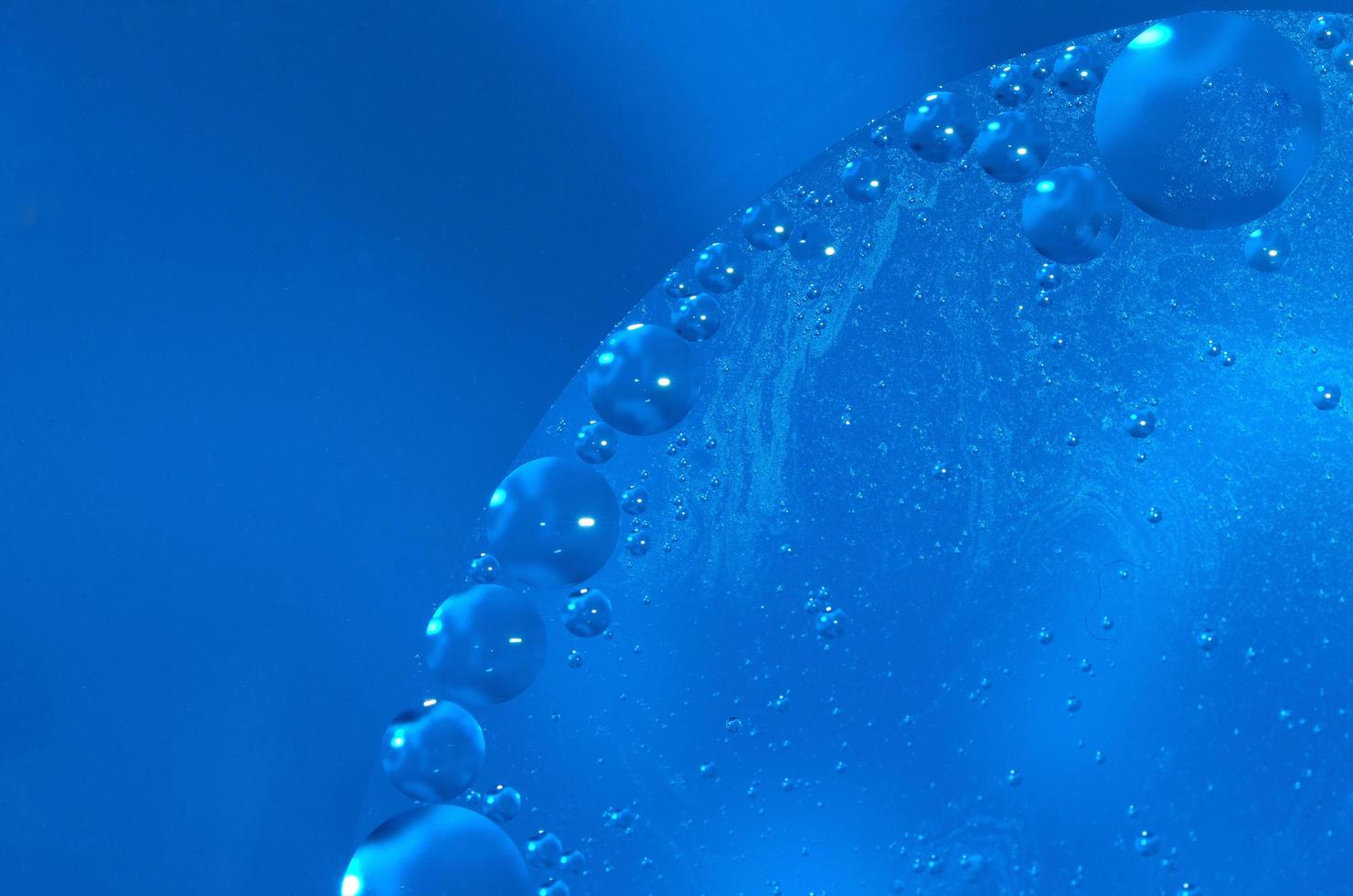oil drops on blue water surface photo