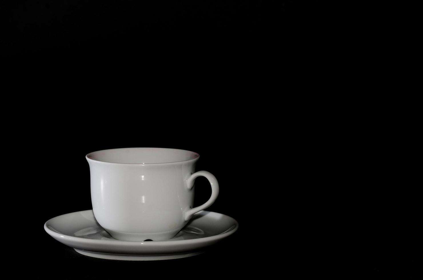 white cup with black background photo