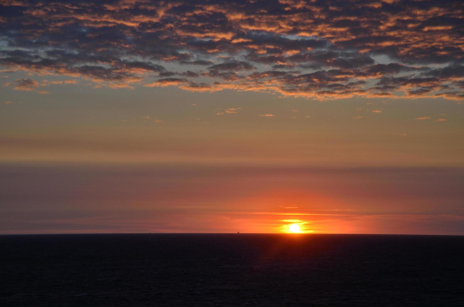 sunset with clouds at sea photo