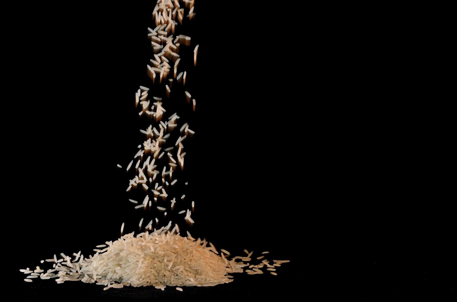 rice trickles with black background photo