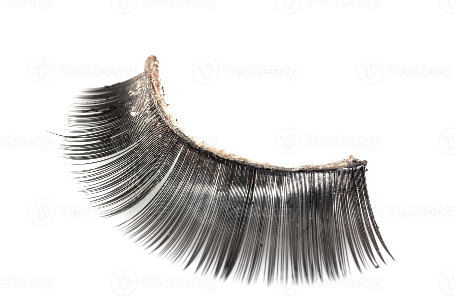 Use of  artificial eyelashes macro Isolated on white background photo