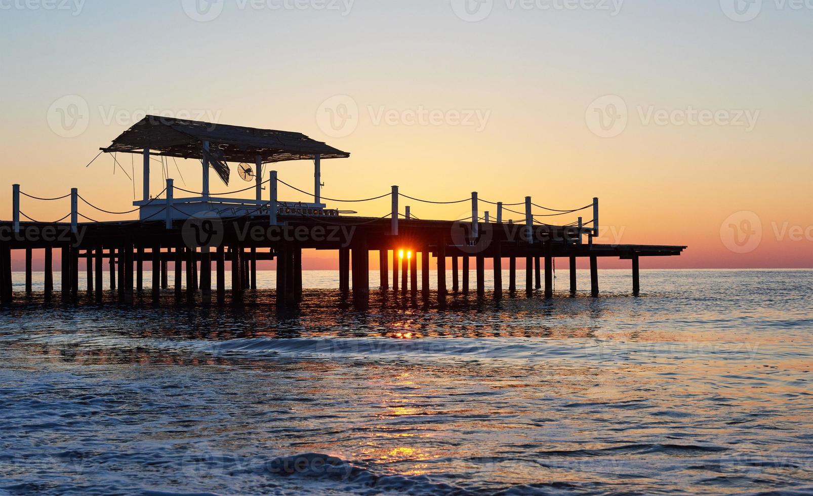 Wooden bridge pier against a beautiful sky measure used for natural background, background and multi-stage sea photo