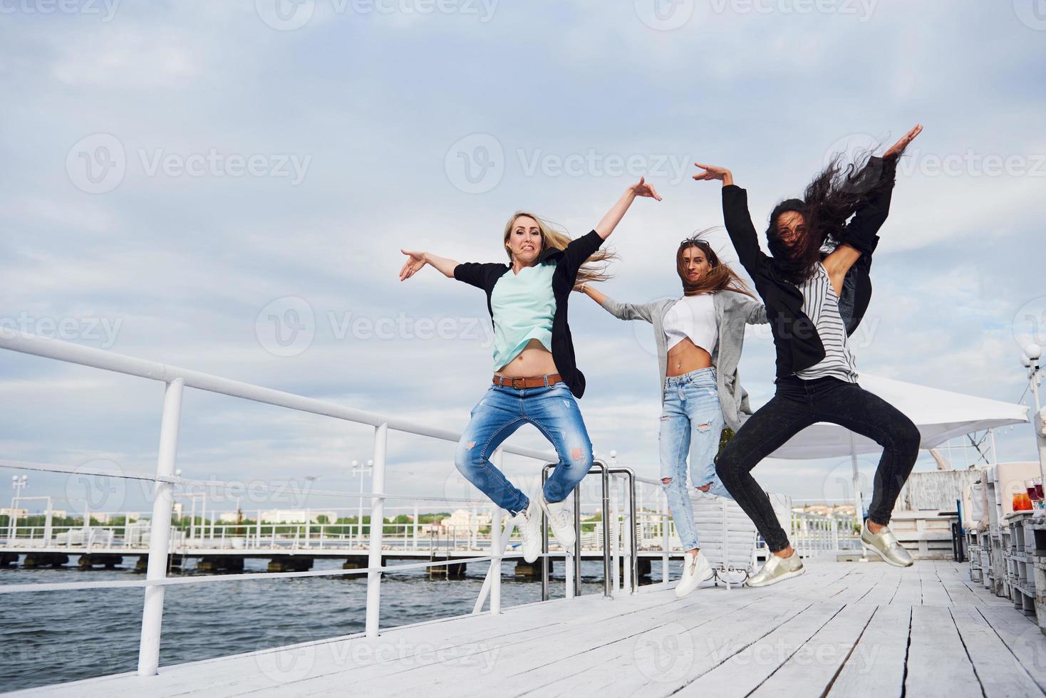 Happy jumping woman taking down the ground. photo