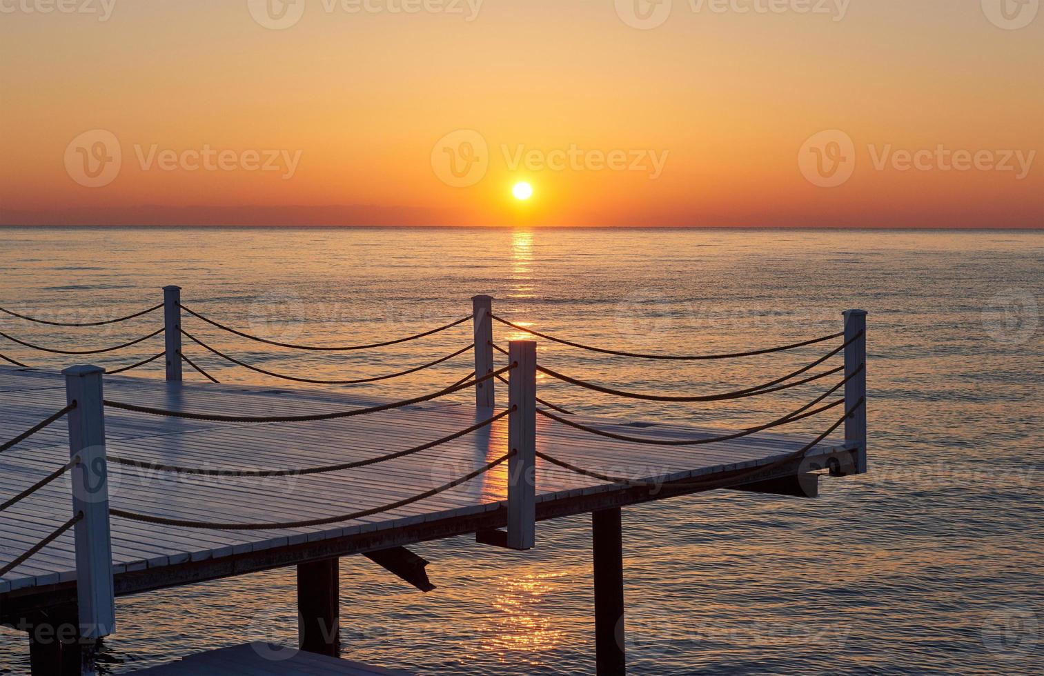 Wooden bridge pier against a beautiful sky measure used for natural background, background and multi-stage sea photo