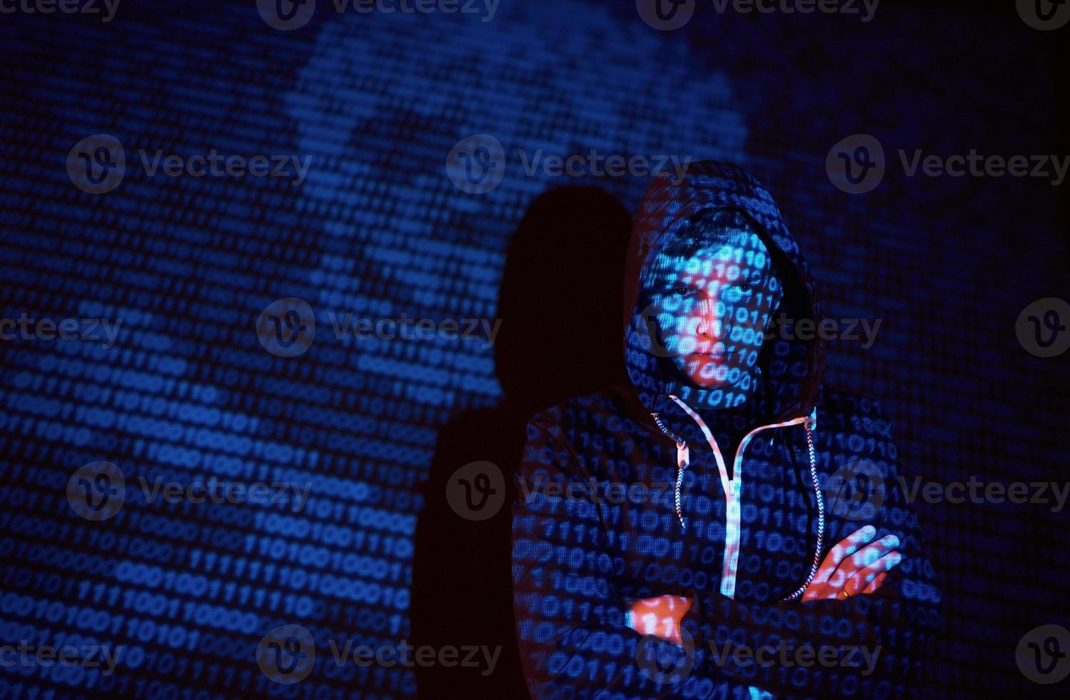 Cyber attack with unrecognizable hooded hacker using virtual reality, digital glitch effect photo
